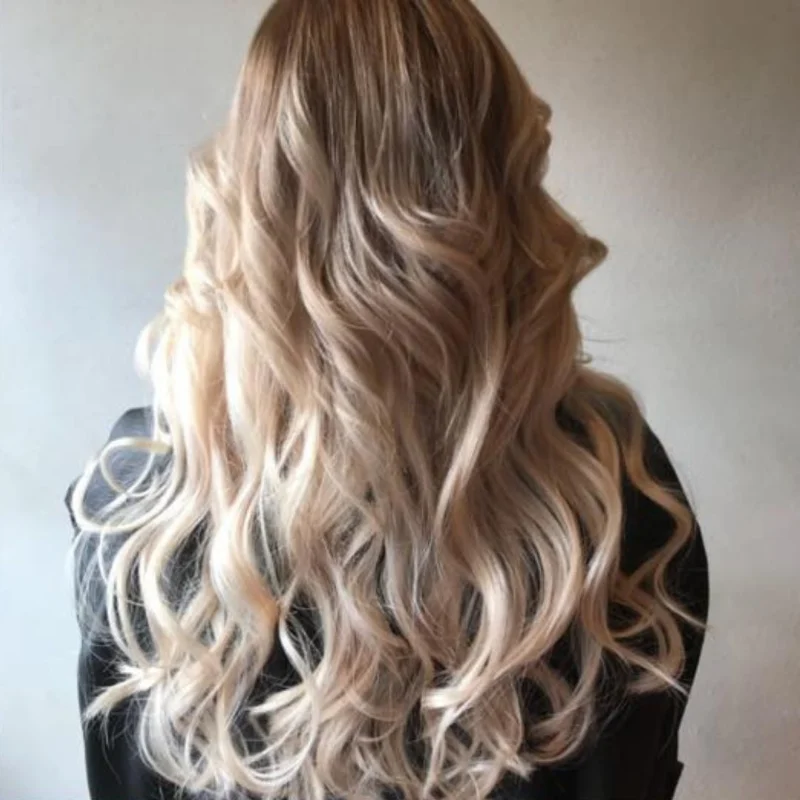 Long blonde hair extensions blended into a soft wave by Hair By Konstantinos Toorak