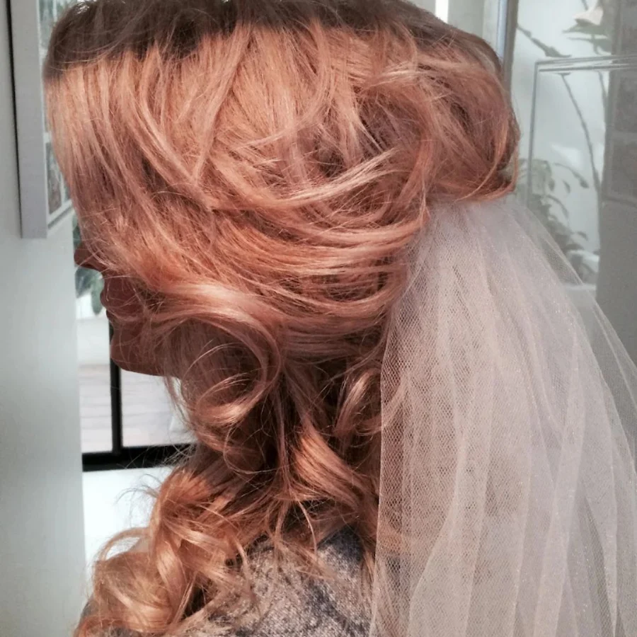 Rose-gold bridal waves swept to one side under a veil, styled at Hair By Konstantinos Toorak